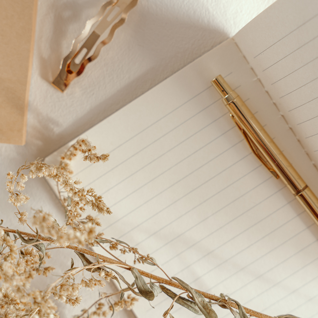 Book and pen for reflection and self-discovery.